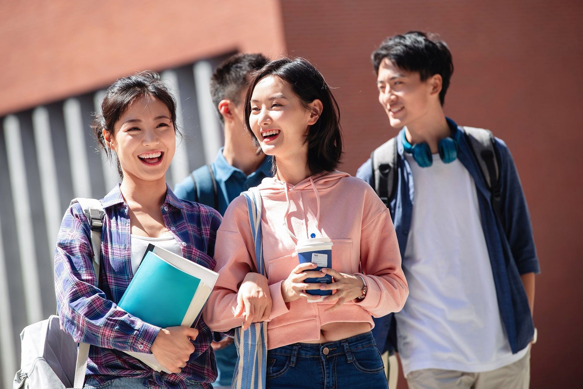 Young people smiling with books.