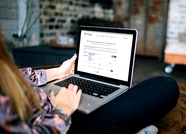 Woman working on laptop at desk.
